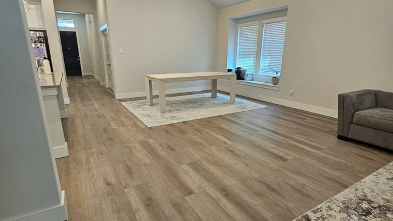 Bright, spacious living room with wide-plank luxury vinyl flooring installed by Flooring and Stone of Denton